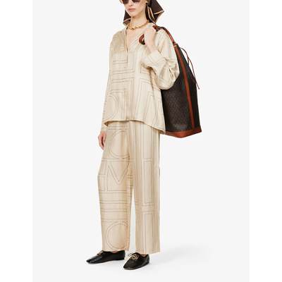Shop Totême Monogram Wide-leg High-rise Silk-satin Pyjama Bottoms In Ivory Monogram