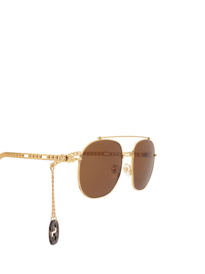 Shop Gucci Gg0727s Gold Sunglasses