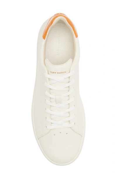 Shop Tory Burch Howell Sneaker In New Ivory / Orange Citrine