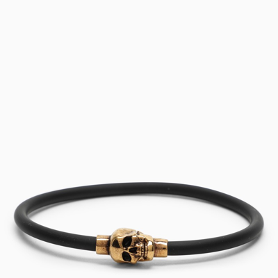 Shop Alexander Mcqueen Gold Skull Bracelet In Black Rubber In Metal