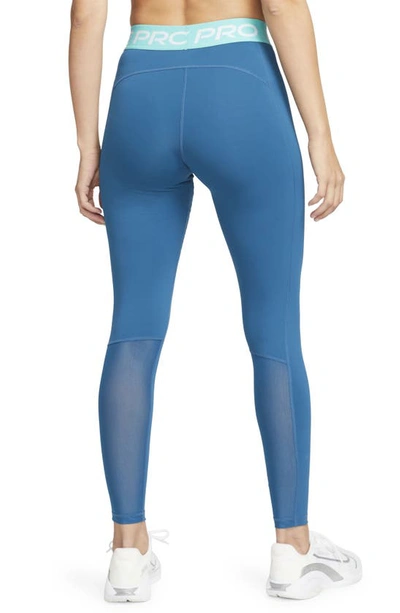 Shop Nike Pro Mid Rise Leggings In Marina/ Washed Teal/ White