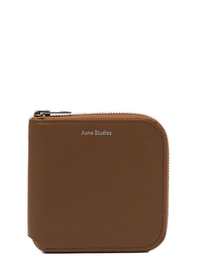 Shop Acne Studios Logo Detailed Medium Zipped Bifold Wallet In Brown