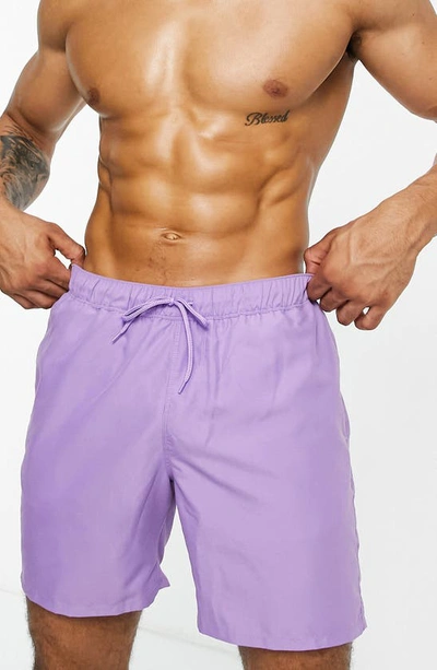 Shop Asos Design Mid-length Solid Swim Trunks In Lilac