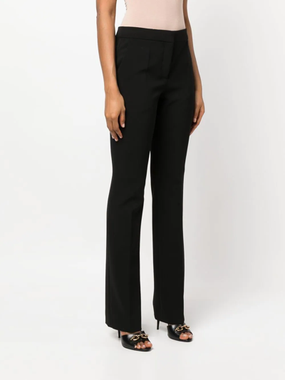 Shop Moschino Flared Mid-rise Trousers In Schwarz