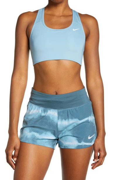 Shop Nike Swoosh Dri-fit Racerback Sports Bra In Worn Blue/ White