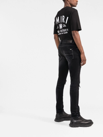 Shop Amiri Ripped-detail Skinny Jeans In Black
