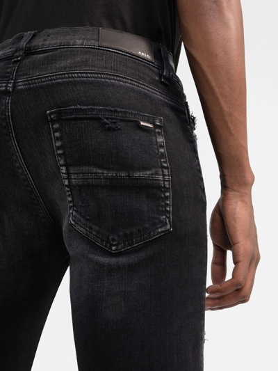 Shop Amiri Ripped-detail Skinny Jeans In Black