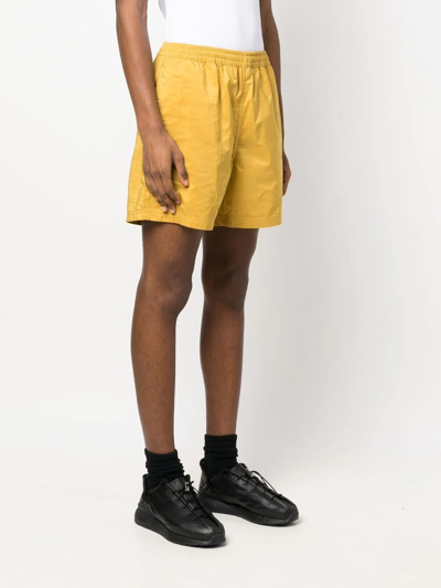 Pleasures Embossed Logo Bermuda Shorts In Yellow