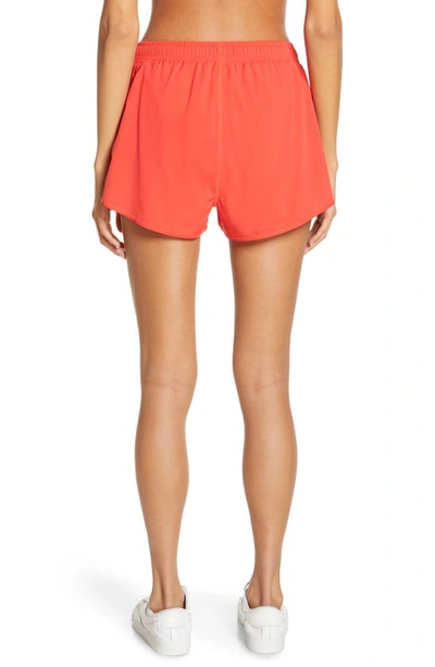 Shop Alo Yoga Stride Shorts In Red Hot Summer