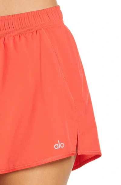Shop Alo Yoga Stride Shorts In Red Hot Summer