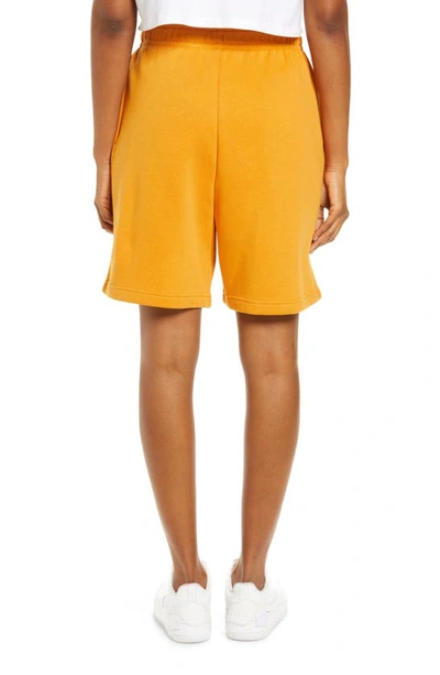 Shop Nike Sportswear Essential Fleece Shorts In Light Curry/ White