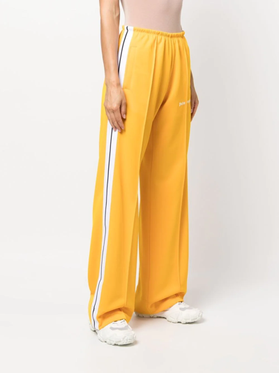 Shop Palm Angels Logo-print Loose-fit Track Pants In Gelb