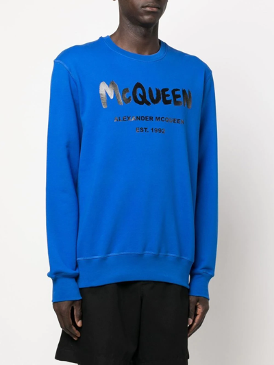 Shop Alexander Mcqueen Logo Graffiti-print Sweatshirt In Blau