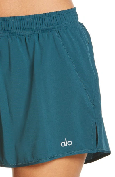 Shop Alo Yoga Stride Shorts In Galactic Teal