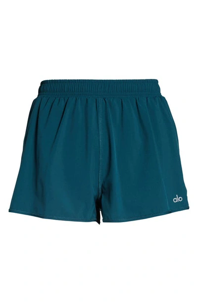 Shop Alo Yoga Stride Shorts In Galactic Teal
