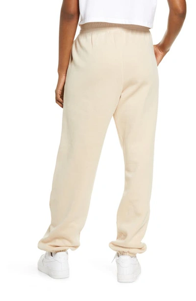 Shop Nike Sportswear Essential Fleece Pants In Sanddrift/ White