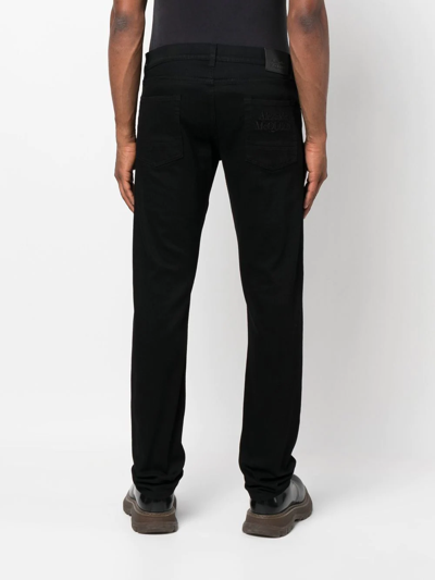 Shop Alexander Mcqueen Straight-leg Logo Jeans In Black