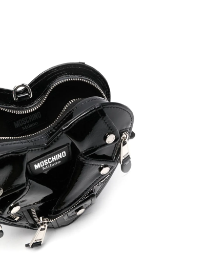 Shop Moschino Biker Jacket Heart Clutch Bag In Schwarz