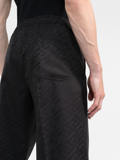 Shop Versace La Greca-print Track Pants In Schwarz