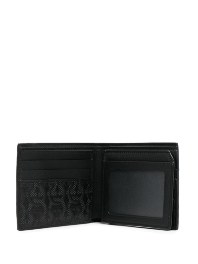Shop Ferragamo Gancini Embossed Bi-fold Wallet In Black