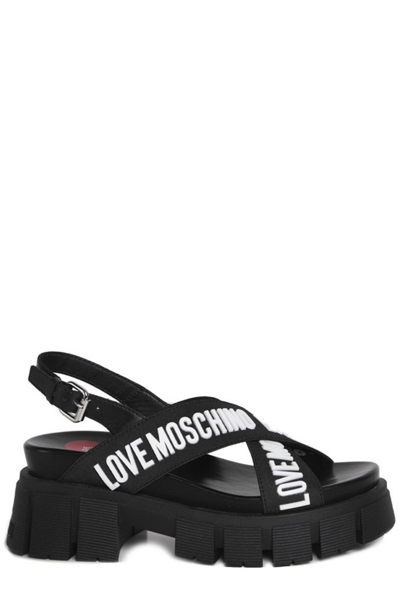 Shop Love Moschino Logo Detailed Crossover Strap Sandals In Black