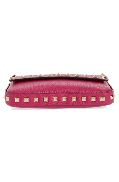 Shop Valentino Rockstud Leather Crossbody Pouch In Rose Violet
