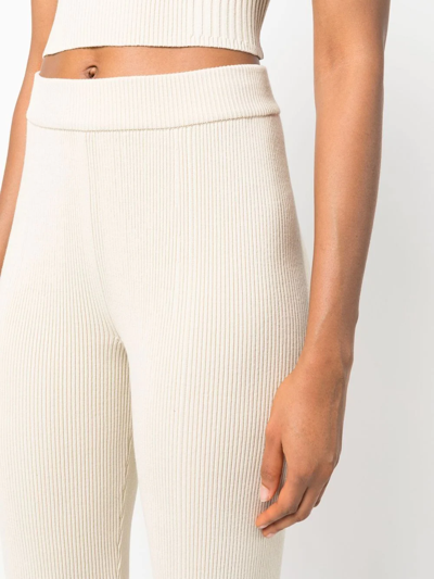 Shop Aeron Ribbed-knit Flared Trousers In Neutrals