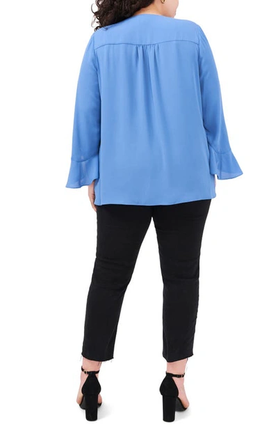 Shop Vince Camuto Flutter Sleeve Crossover Georgette Tunic Top In Steel Blue