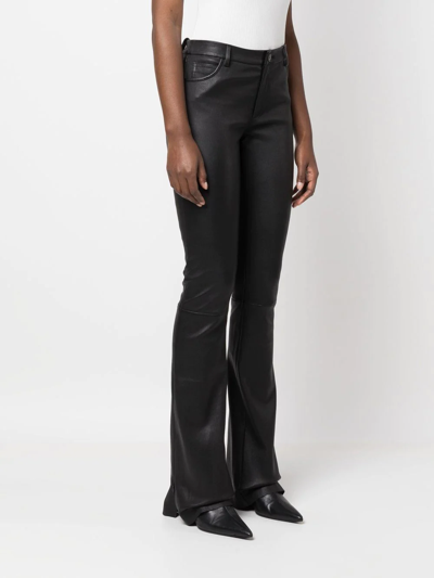 Shop Drome Flared Leather Trousers In Schwarz