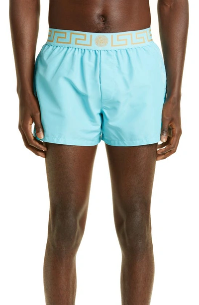 Shop Versace Greca Band Swim Trunks In Light Blue Gold