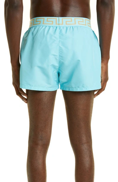 Shop Versace Greca Band Swim Trunks In Light Blue Gold