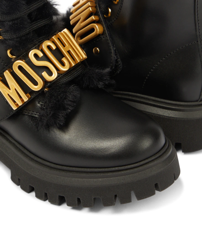 Shop Moschino Logo Leather Boots In Black / Gold