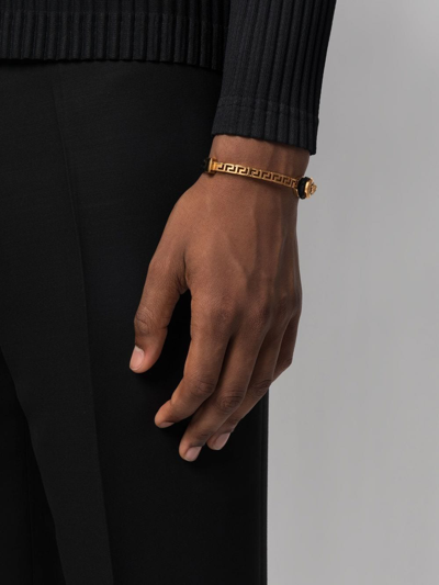 Shop Versace Greca Braided Leather Bracelet In Gold