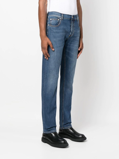 Shop Alexander Mcqueen Embroidered-logo Slim-fit Jeans In Blue