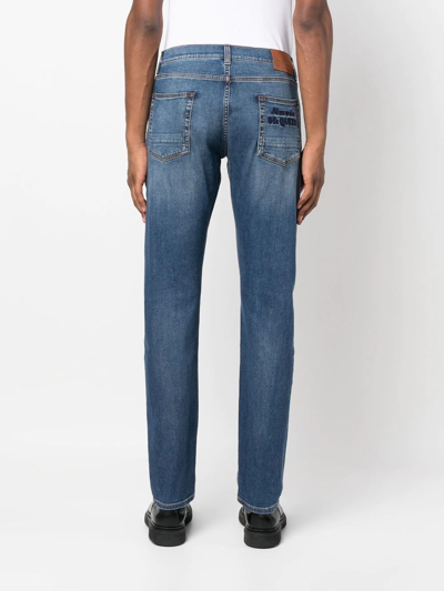 Shop Alexander Mcqueen Embroidered-logo Slim-fit Jeans In Blue