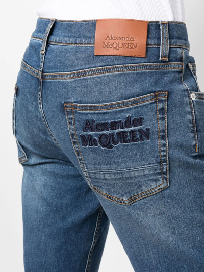 Shop Alexander Mcqueen Embroidered-logo Slim-fit Jeans In Blue