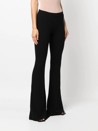 Shop Versace Ribbed-knit Flared Trousers In Black