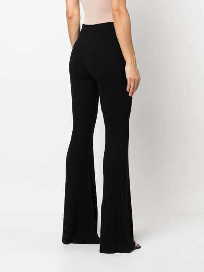 Shop Versace Ribbed-knit Flared Trousers In Black