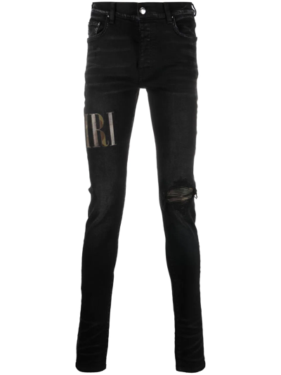 Amiri Old English Logo Distressed Denim Jeans In Black