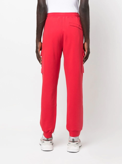 Shop Stone Island Tapered-leg Track Pants In Red