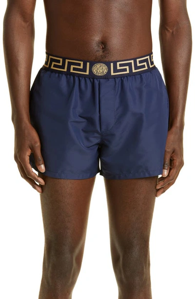 Shop Versace Greca Band Swim Trunks In Blu/ Gold