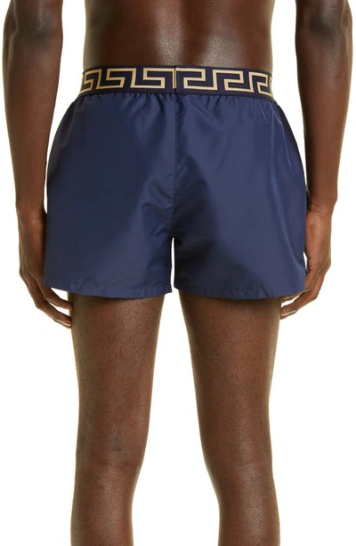 Shop Versace Greca Band Swim Trunks In Blu/ Gold