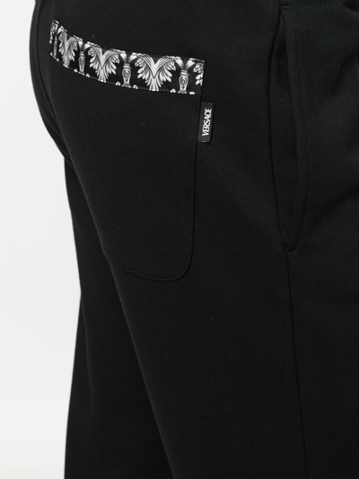 Shop Versace Rear Baroque-print Detail Trousers In Black