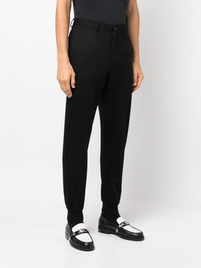 Shop Prada Tapered Cotton Trousers In Schwarz