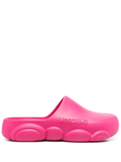 Shop Moschino Logo Embossed Mules In Pink