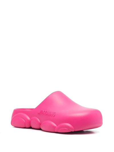 Shop Moschino Logo Embossed Mules In Pink