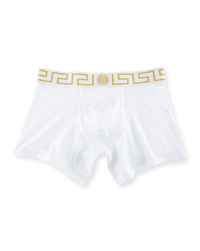 Shop Versace Greca Border Long Boxer Trunks In White/gold