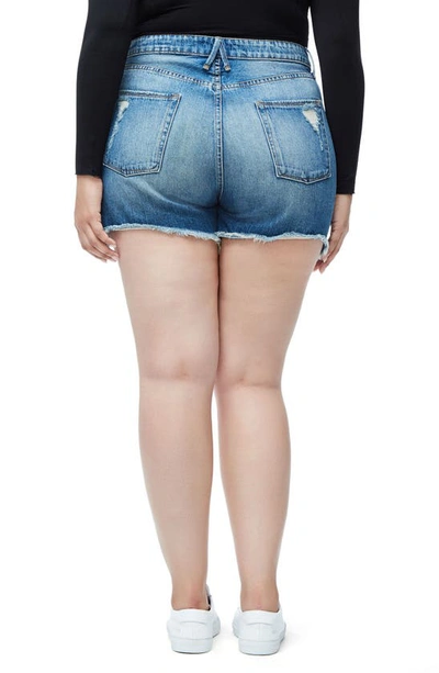 Good American Bombshell Distressed Denim Cutoff Shorts In Blue153