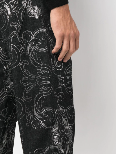 Shop Versace All-over Baroque-print Denim Jeans In Black