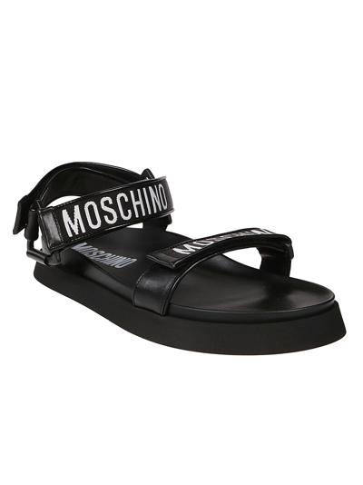 Shop Moschino Fussbet40 Logo Strap Sandals In Black